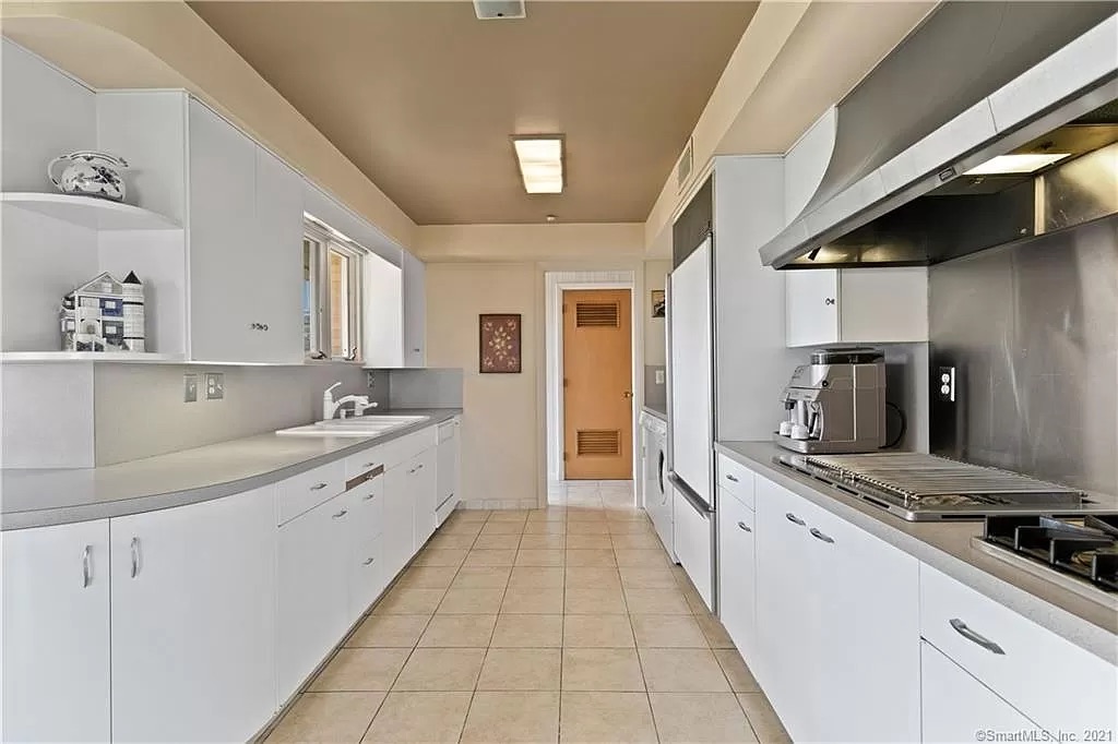Kitchen view showing cramped layout and old cabinetry prior to remodel