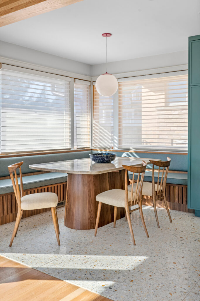 Custom breakfast nook with built-in seating and cozy corner lighting in renovated kitchen