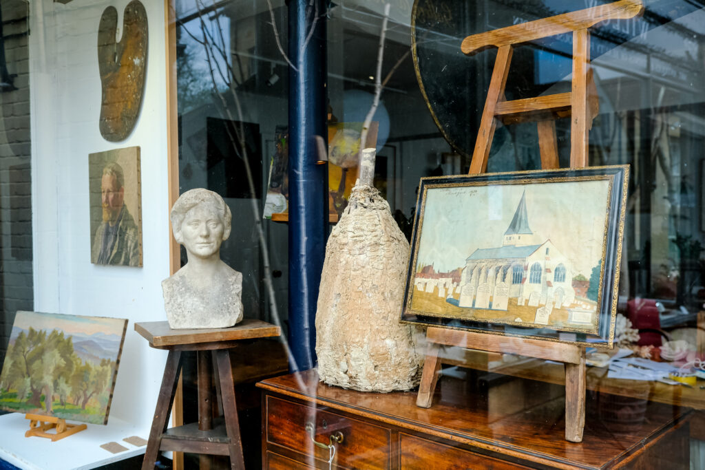 Thrift store display featuring unique art pieces and decorative objects for budget-friendly home styling