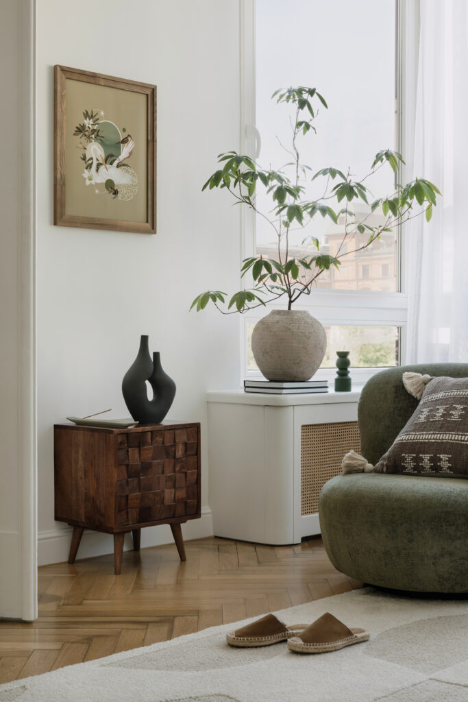 Curated living room vignette with bold artwork and a large decorative vase, showing modern design accents